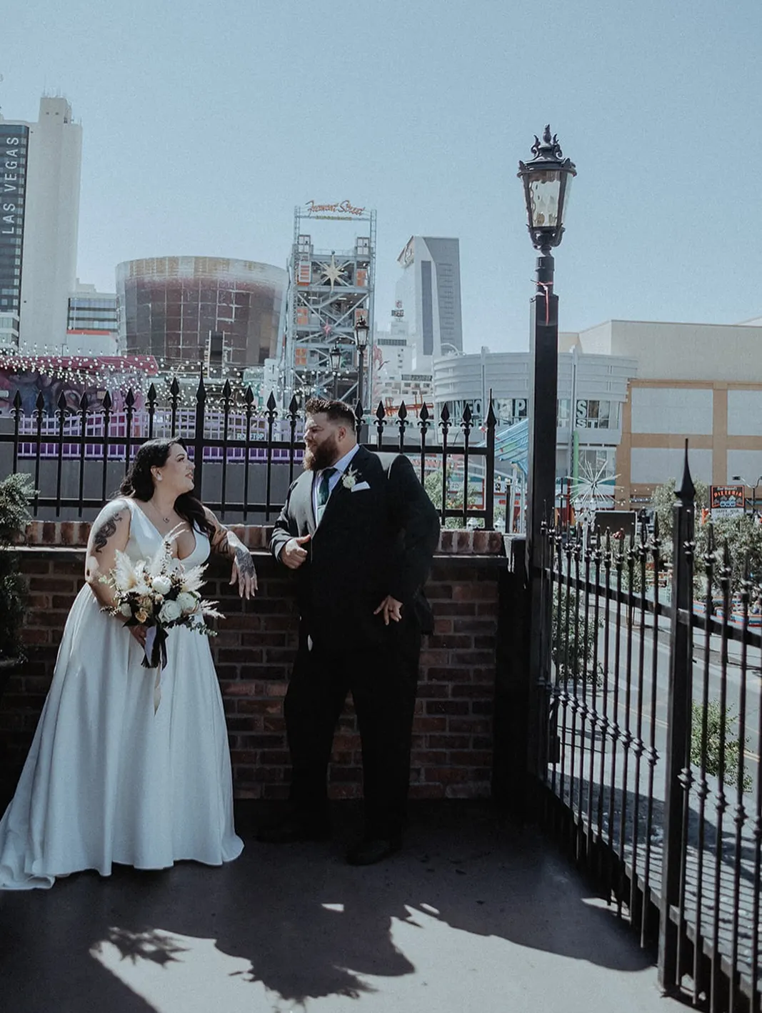 Bride and groom with the downtown Las Vegas skyline behind them
